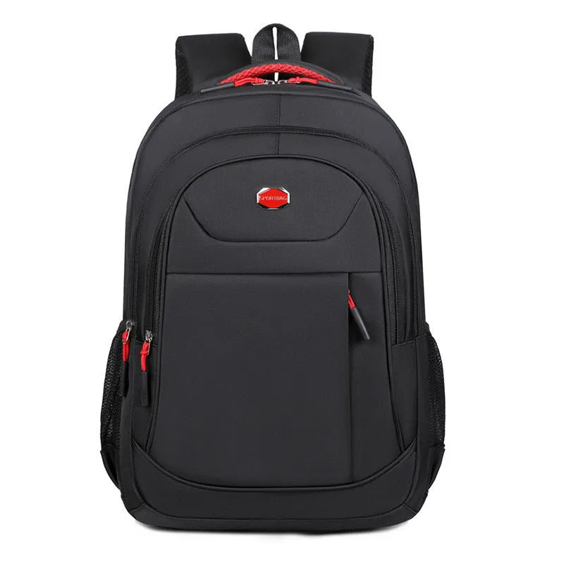 Solid colour Oxford cloth backpack with curved shoulder straps, shown in black, blue, green, or red.