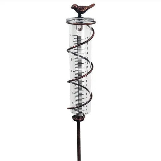 Cast iron hummingbird garden rain gauge with glass tube showing water measurement scale.