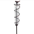 Cast iron hummingbird garden rain gauge with glass tube showing water measurement scale.