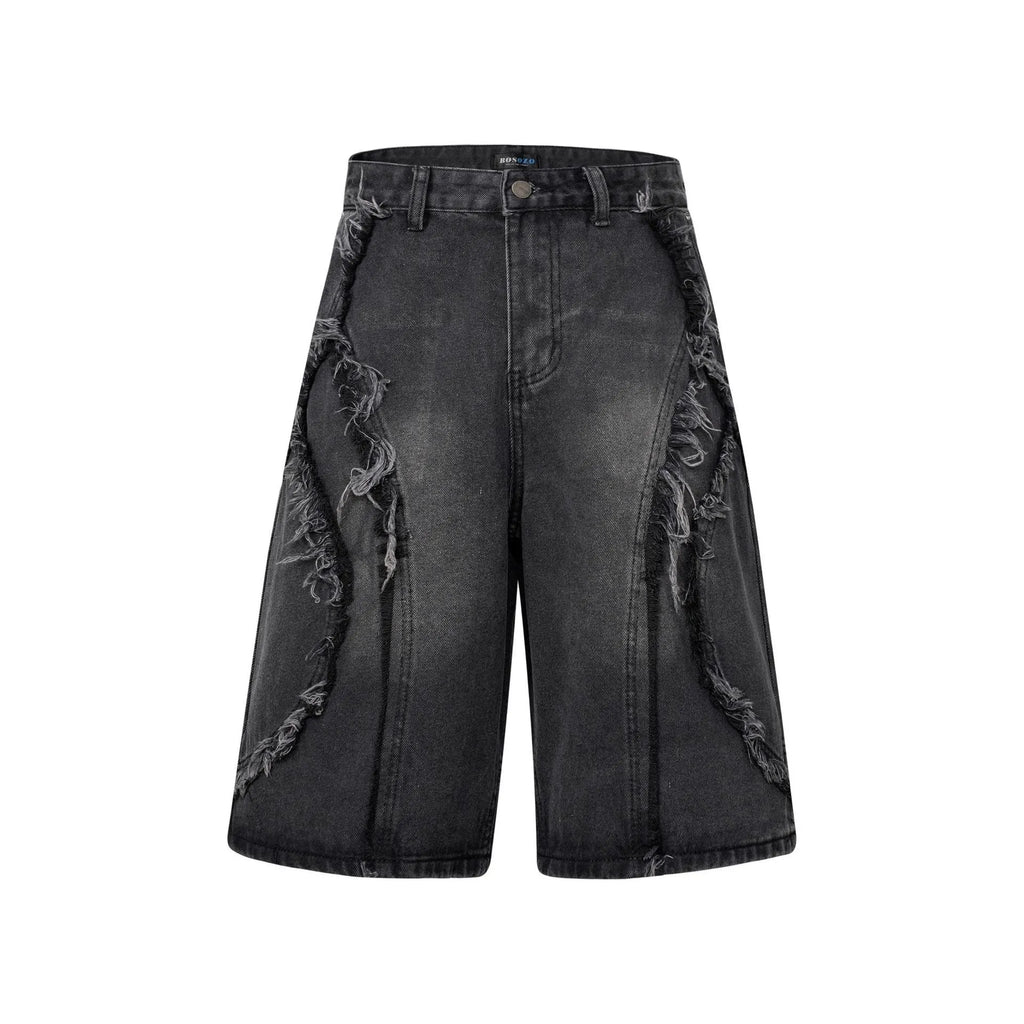 Distressed raw edge denim shorts in a straight-leg cropped fit on a hanger.