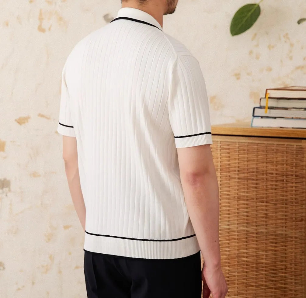 Slim-fitting black short-sleeved polo shirt with a lapel collar, made from a knitted viscose and polyester fabric blend.