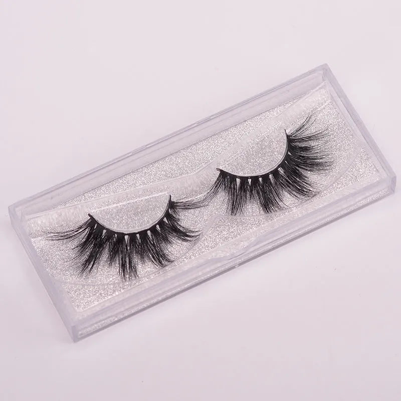 5D mink false eyelashes with protective hair cap and double-headed brush on white background