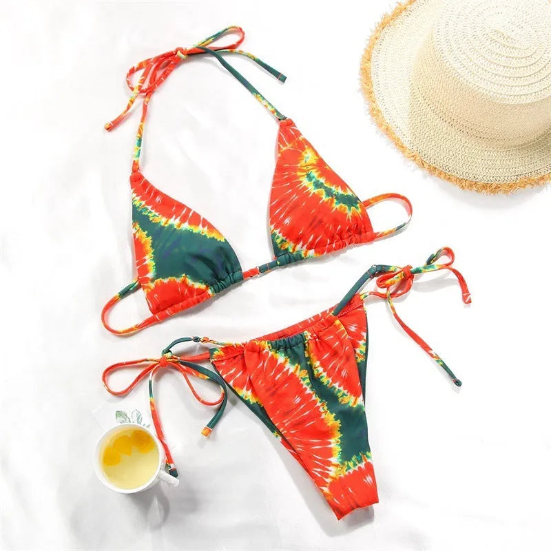 Women's polka dot print split swimsuit bikini set in polyester on a mannequin.