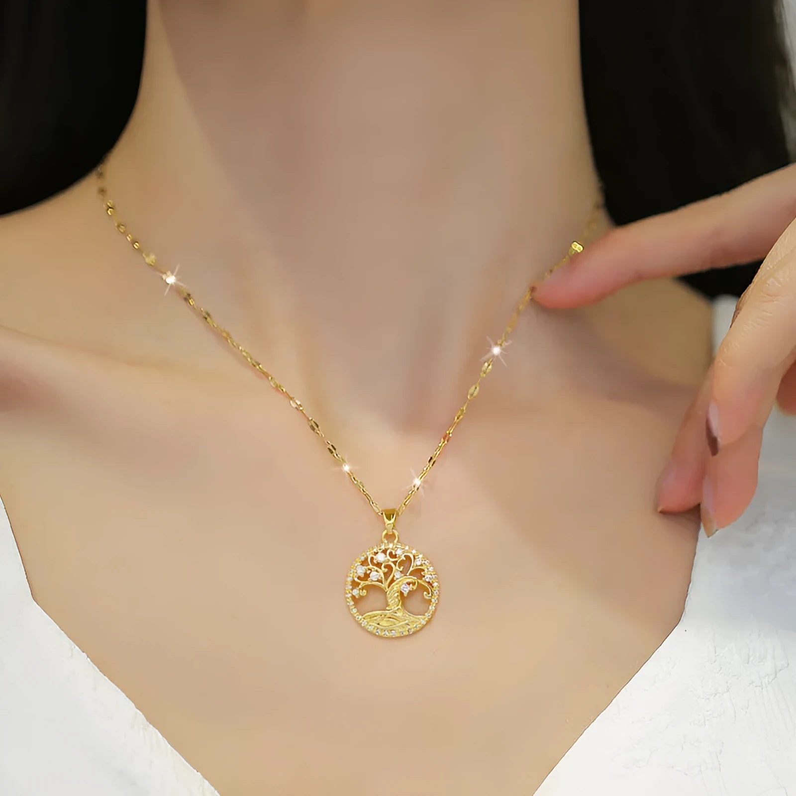 Gold plated necklace with tree and cross pendant featuring mother of pearl and rhinestones on adjustable chain