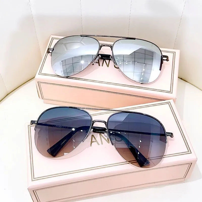 Gold frame aviator-style metal driving sunglasses with resin lenses for UV protection.