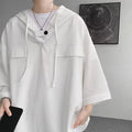 Man wearing a loose black hooded short sleeve t-shirt, a summer casual pullover top.