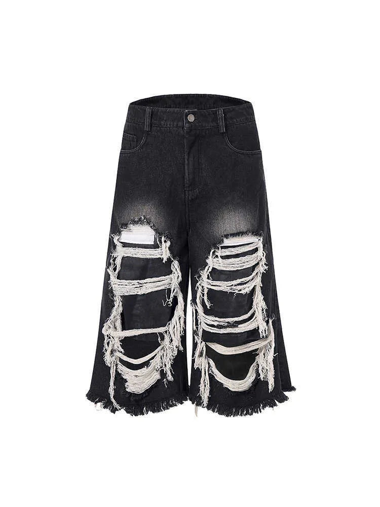 Women's black cropped wide leg jeans with mid-high waist and ripped patch detailing