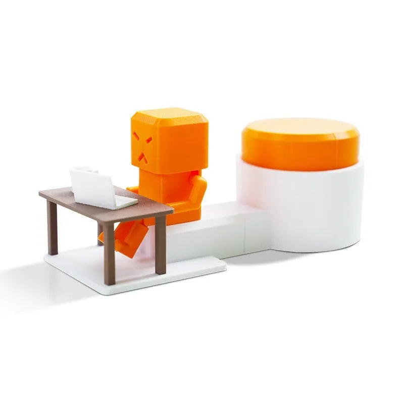 Orange plastic table-turning decompression toy measuring 16cm long on a desk