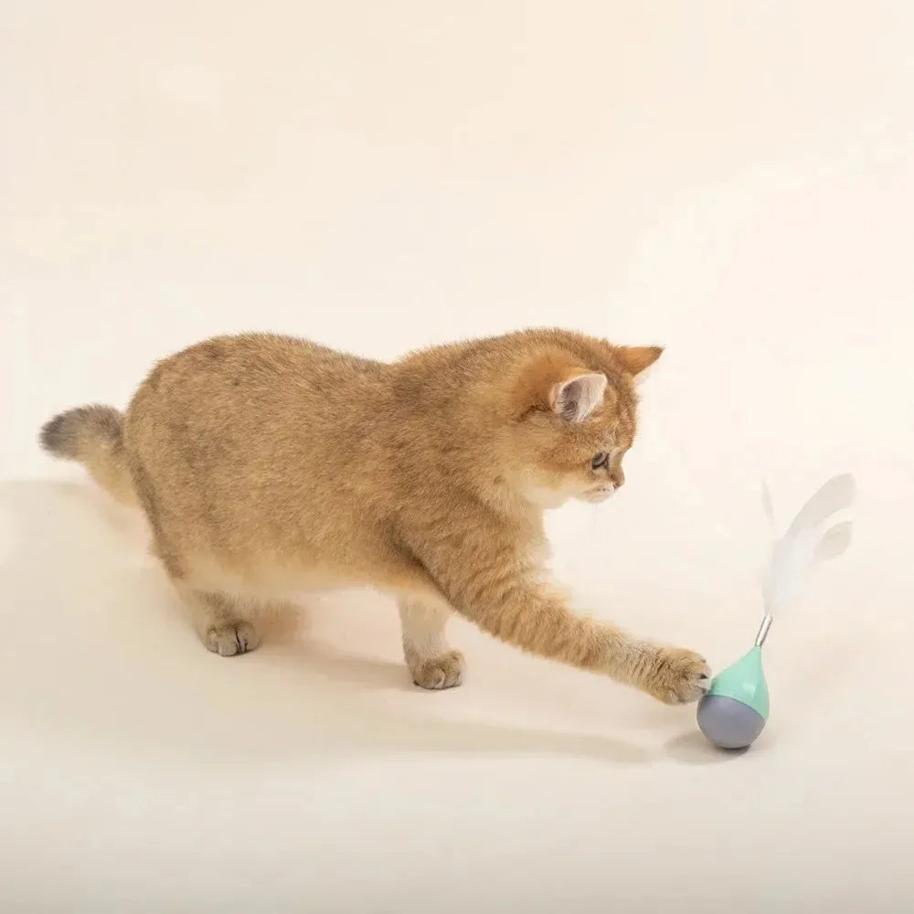 Green and pink feather tumbler cat toy with self-healing design