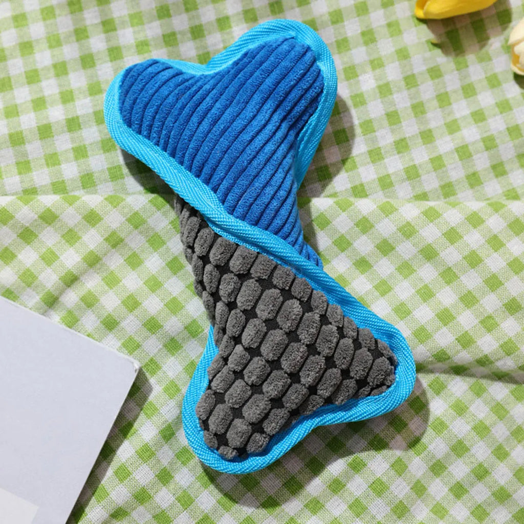 Soft teddy bear dog toy with squeaker and bone accessory in blue, green, and pink colours