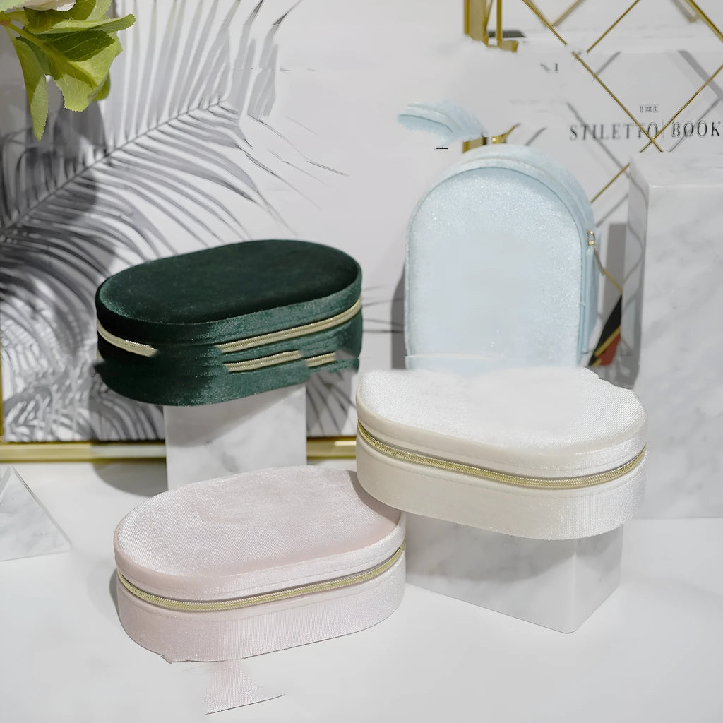 Oval velvet jewellery storage box in lake blue colour, showing soft flannel interior, dimensions 15cm long.