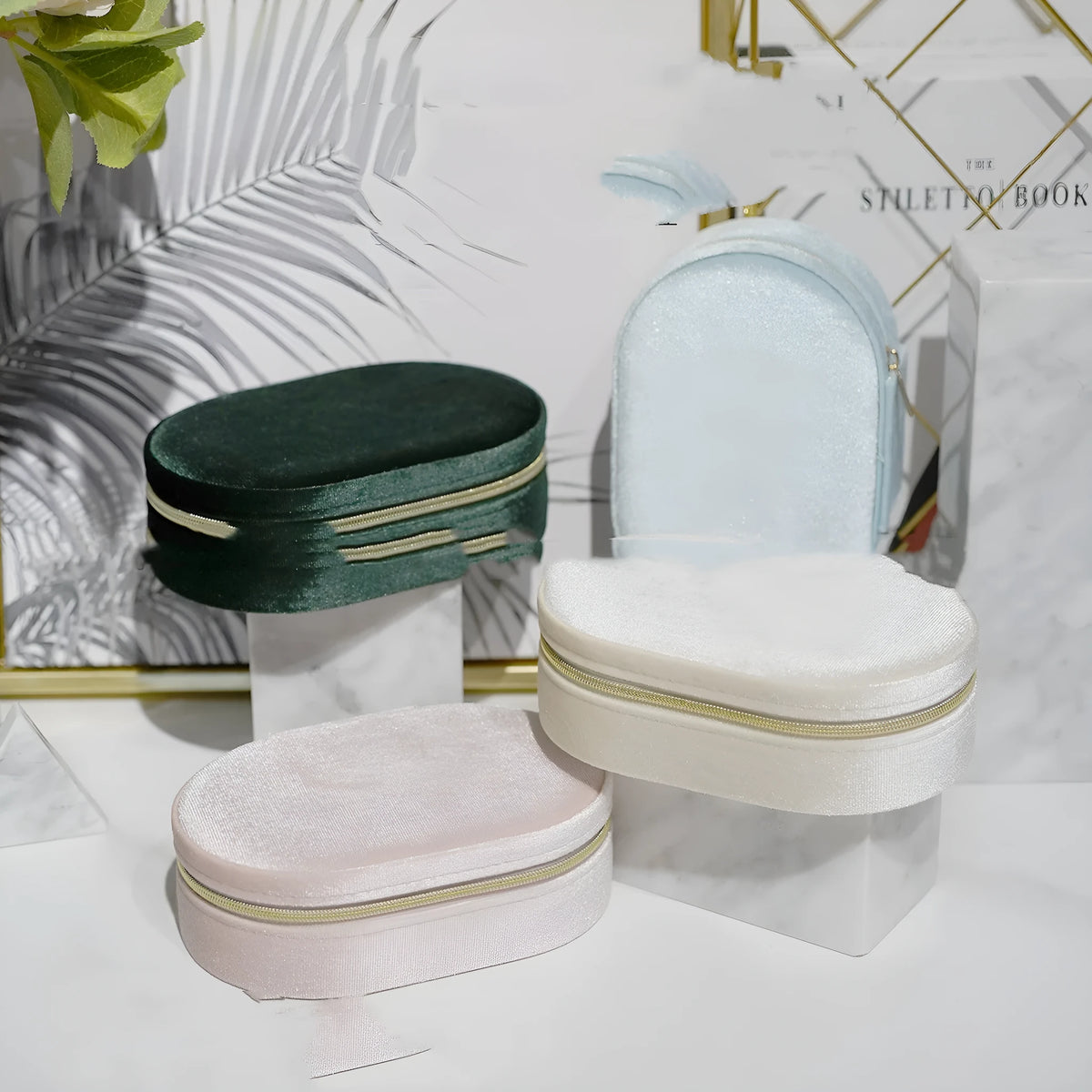 Oval velvet jewellery storage box in lake blue colour, showing soft flannel interior, dimensions 15cm long.