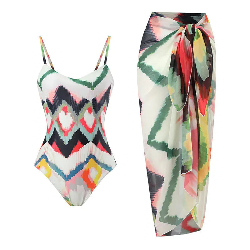 Women's two-piece striped swimsuit with a matching gradient print hip skirt laid flat.