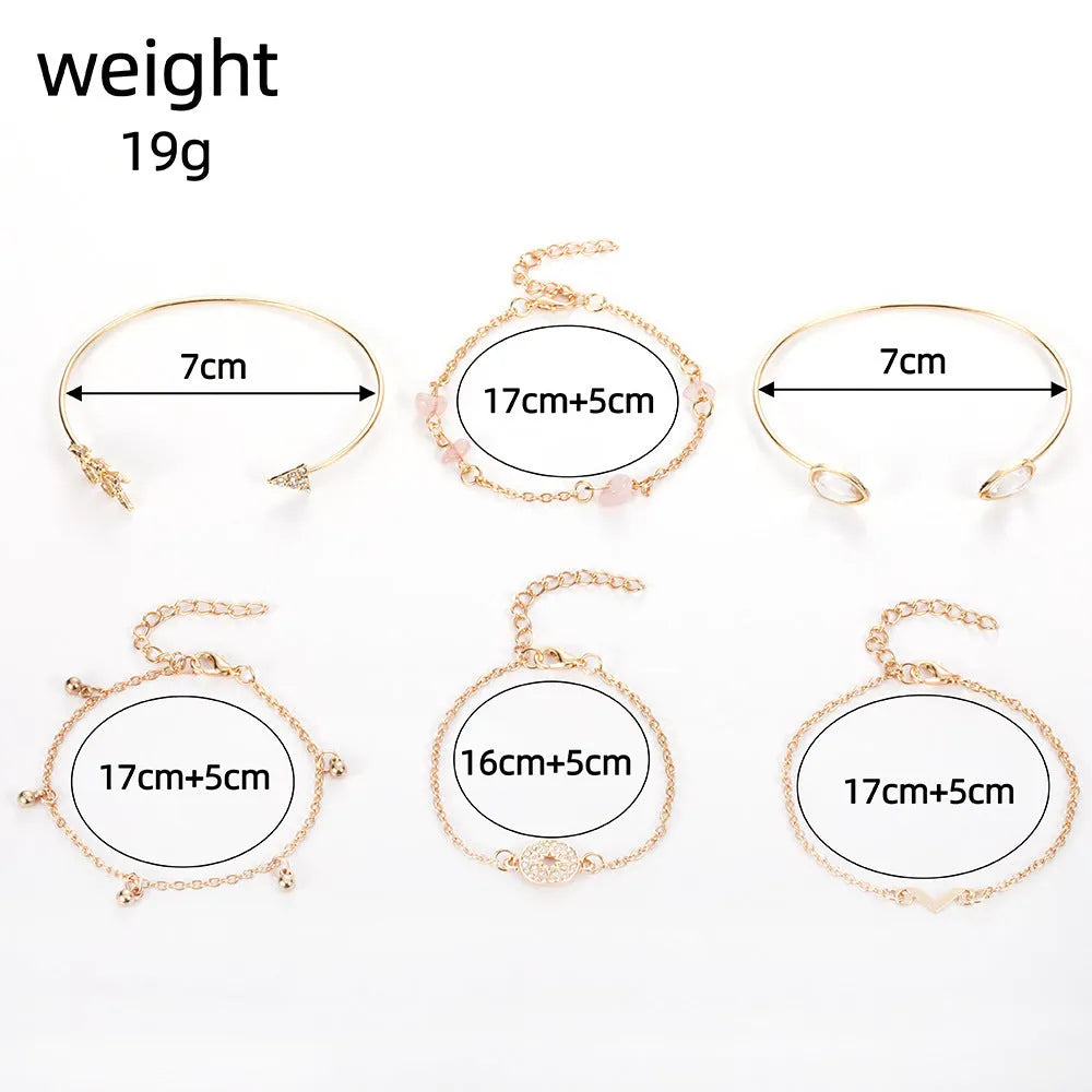 Set of six golden bracelets with arrow, water drop and V shapes featuring spot drill pattern.
