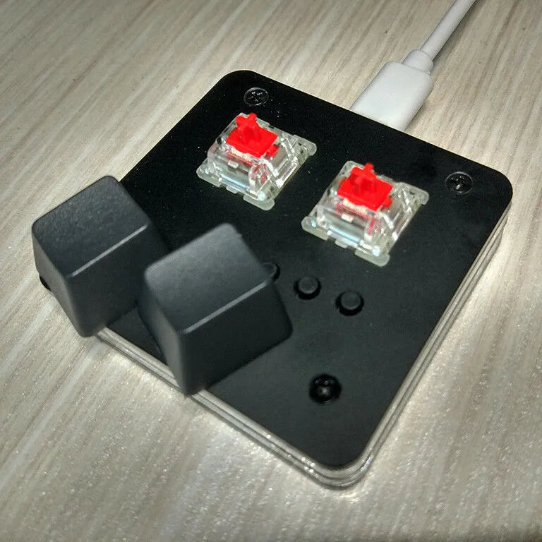 Compact white mini USB keyboard with multimedia keys on a desk.