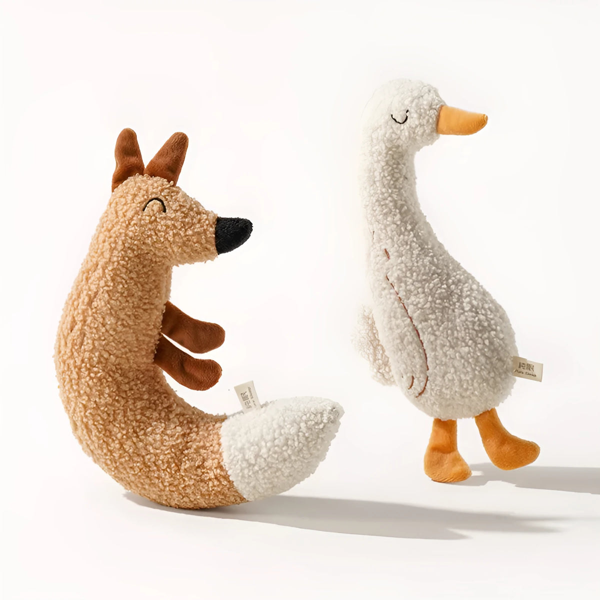 Cartoon dog chew toy in duckling yellow or fox orange with teddy velvet fabric and crinkle sound.