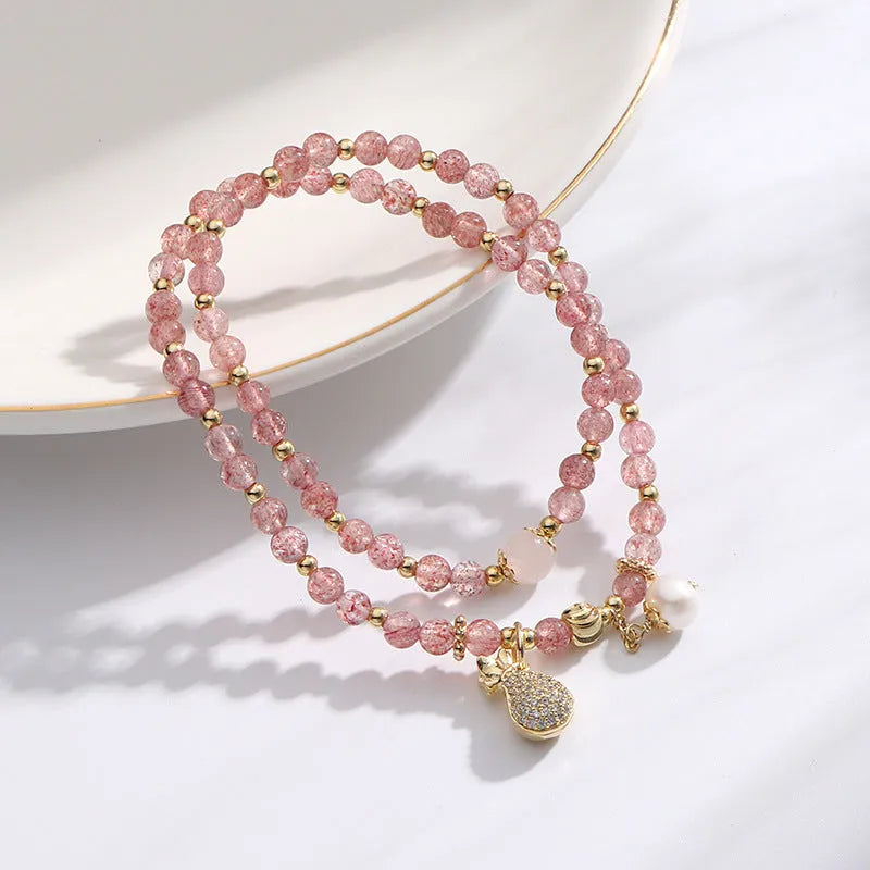 Women's geometric strawberry quartz crystal bracelet for money drawing and luck.