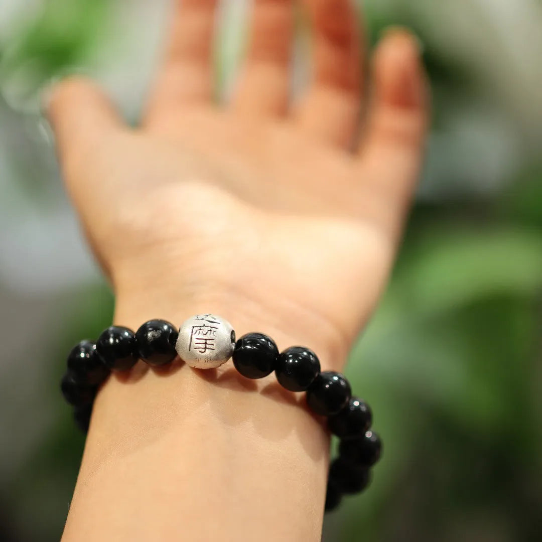 Black agate bracelet with sterling silver clasp showing Chinese style design
