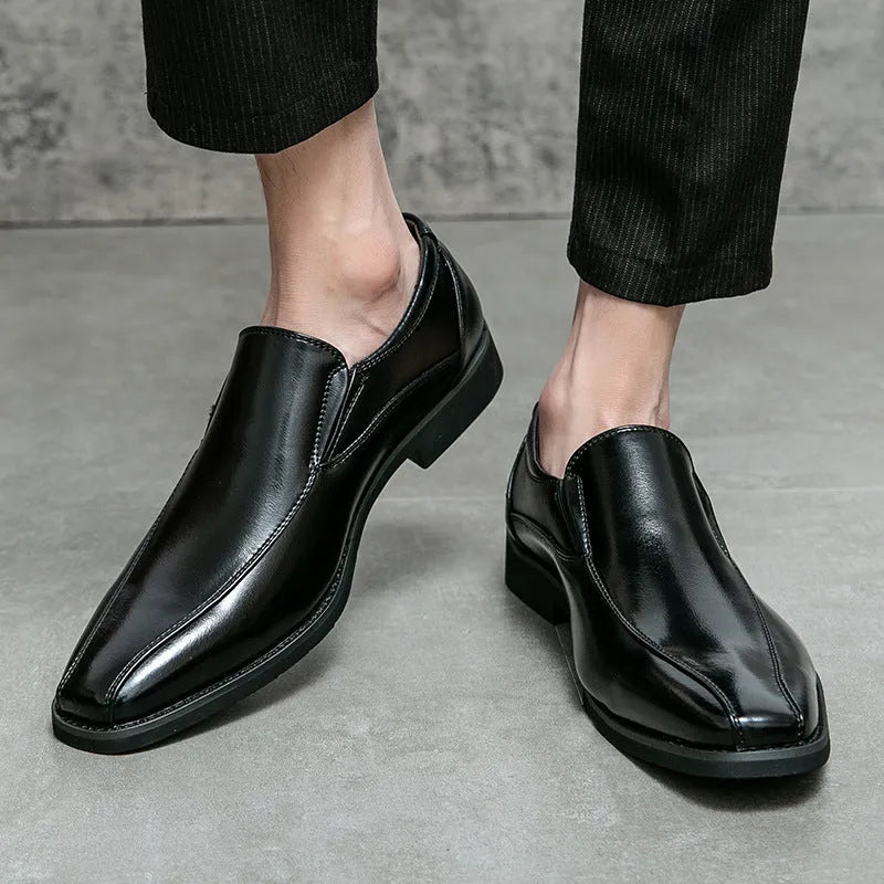Men's black patent leather pointed toe casual shoes with a flat heel and totem design on a white background.