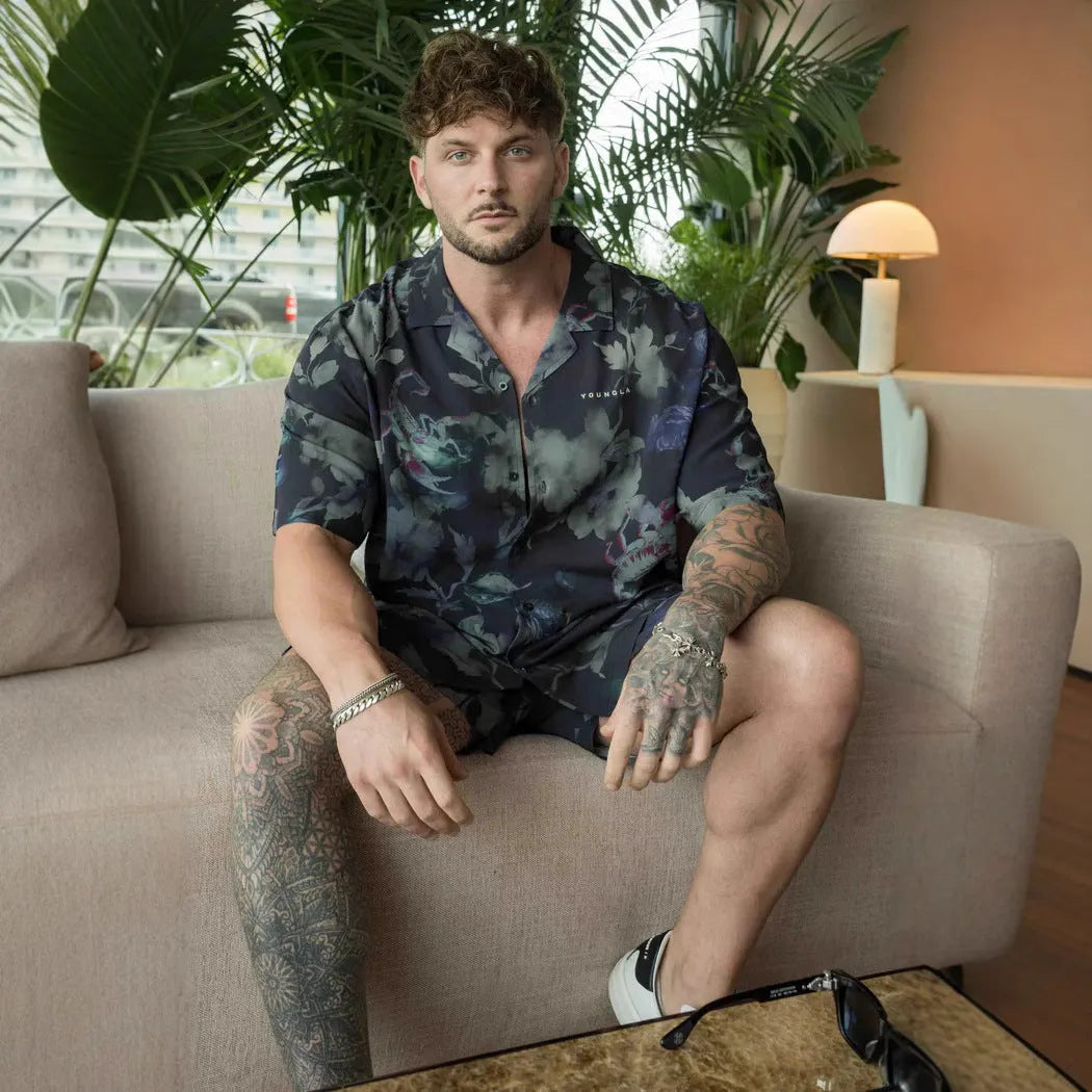 Man wearing a loose fit, short sleeve printed floral top in a neutral colour