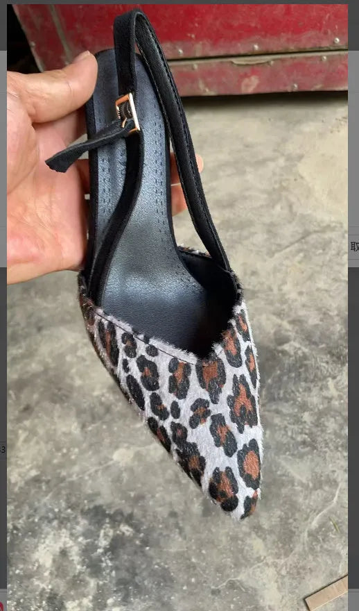 Women's leopard print suede sandals with a pointed toe design on a white background.