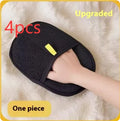 Black pet hair removal glove with silicone bristles on a hand, grooming a dog.