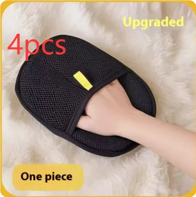 Black pet hair removal glove with silicone bristles on a hand, grooming a dog.