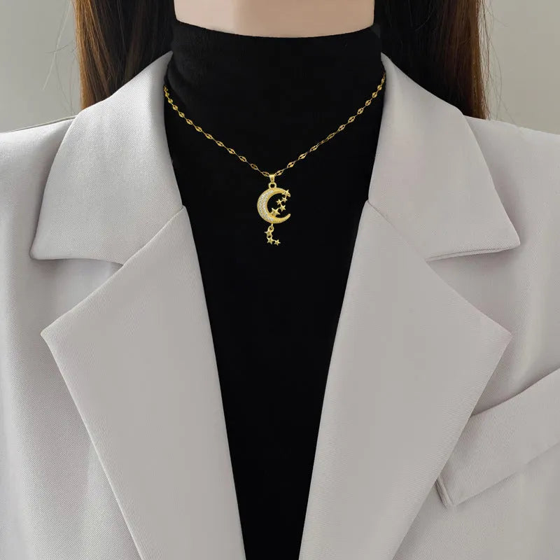 Geometric moon pendant necklace with diamond accents on stainless steel chain, copper pendant with tassel styling