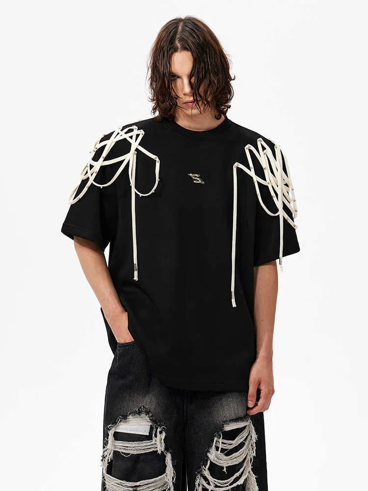 Black loose fit short-sleeved t-shirt with padded shoulder detail and rivet ribbon accents