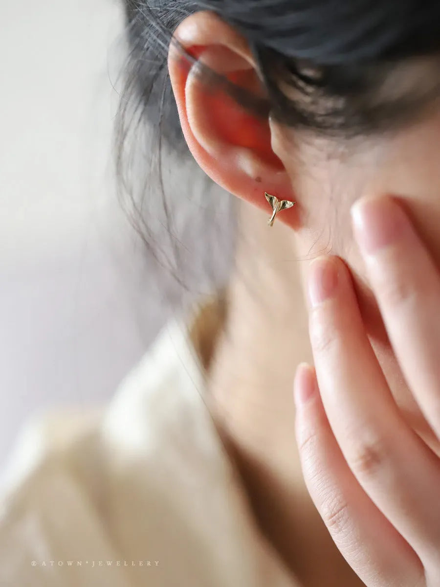 Gold plated sterling silver fish tail earrings for women, showing simple design and smooth finish.