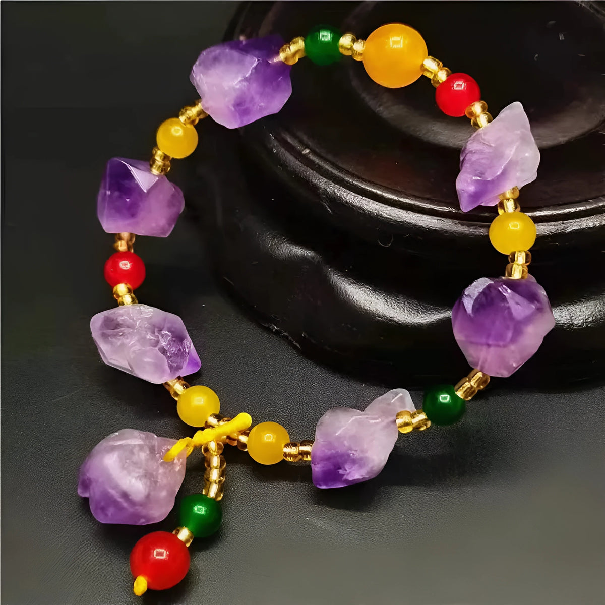 Women's amethyst bead bracelet with natural-shaped stones and fu character charm on adjustable beaded design