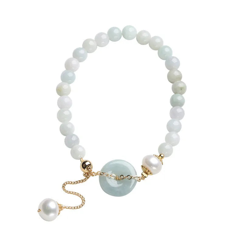 Natural emerald jade bracelet with pearl elements and peace buckle charm on adjustable cord