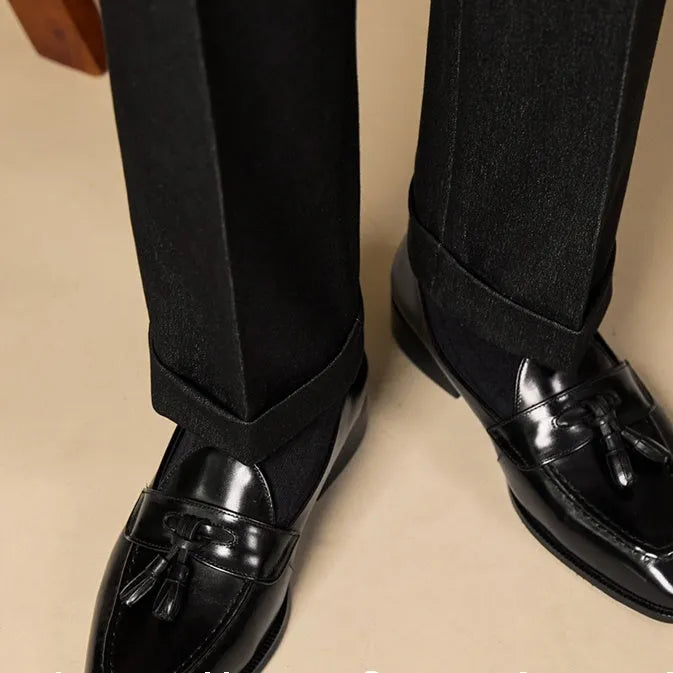 British-style leather tassel loafers in polished black leather with rubber sole