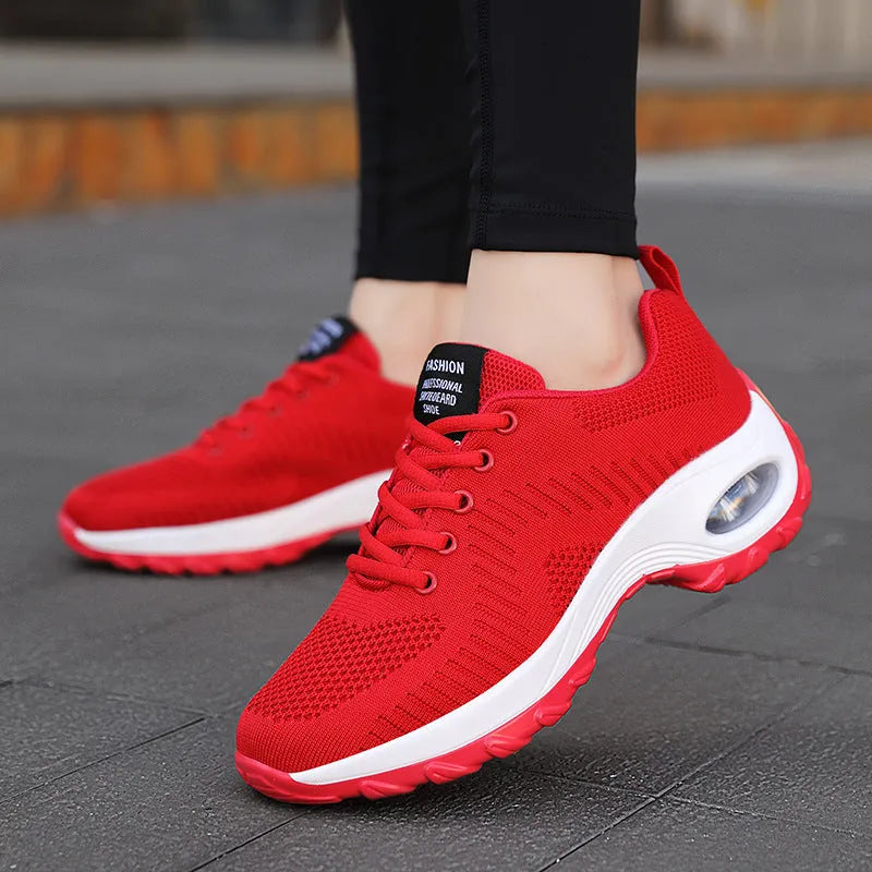 Women's red mesh sneakers with round toe and front lace-up design on flat heel
