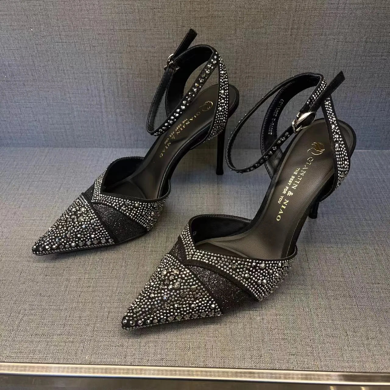 Women's black hollow high heels with red sole and pointed toe stiletto design
