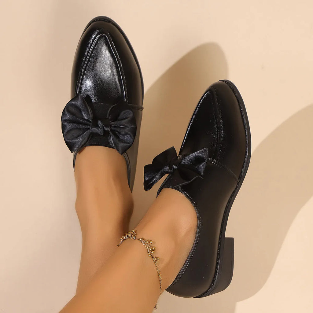 Women's simple leather shoes with bow decoration in British style, showing pointed toe and rubber sole