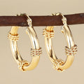 Geometric copper ear clips with ring and line patterns in three golden finish options