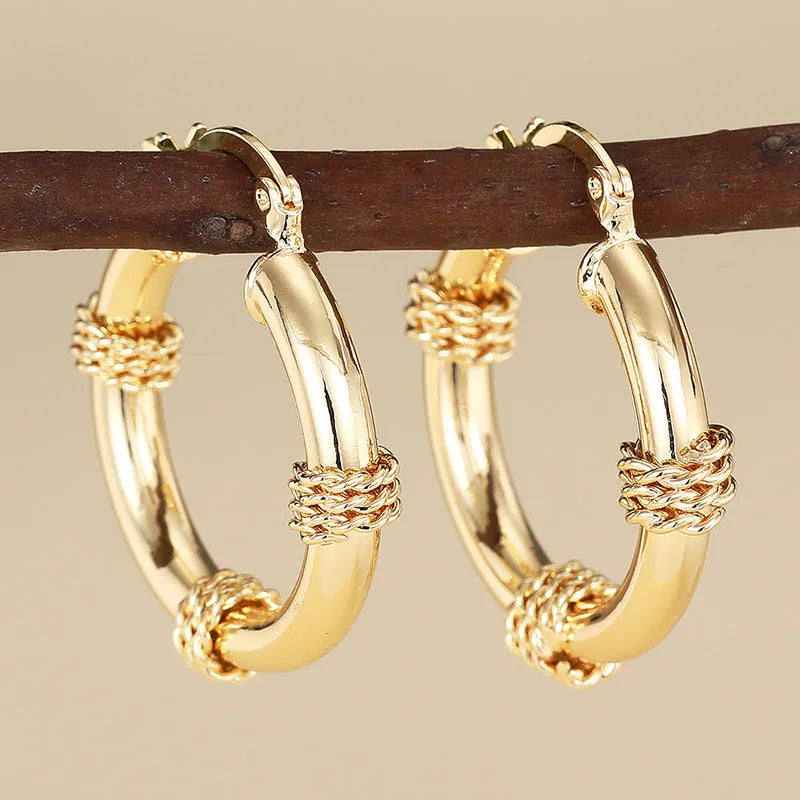 Geometric copper ear clips with ring and line patterns in three golden finish options
