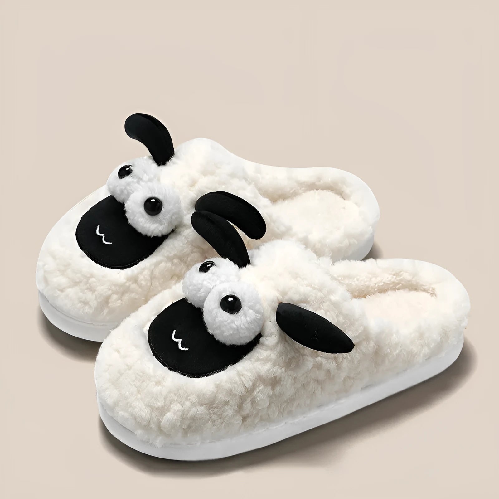 A pair of lamb thermal cotton slip-on slippers with a suede upper and sewn PVC sole.