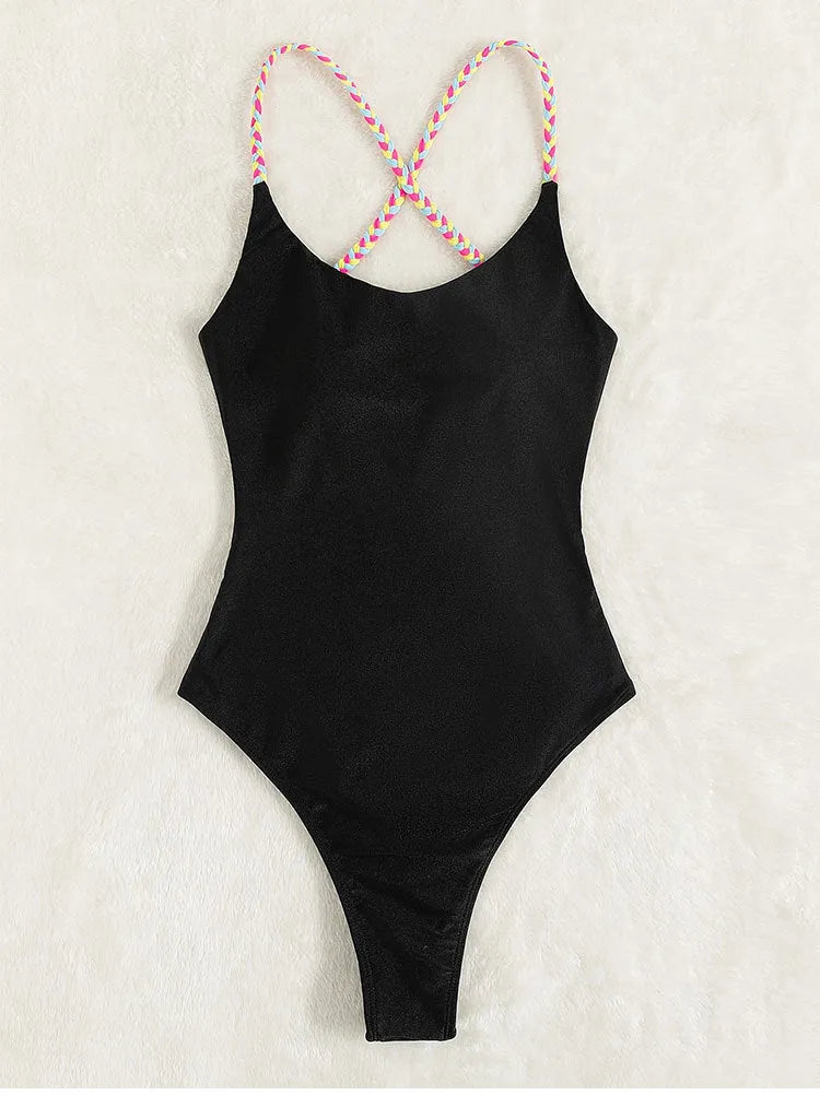 Black solid colour women's one-piece swimsuit with a backless and sleeveless design on a mannequin.