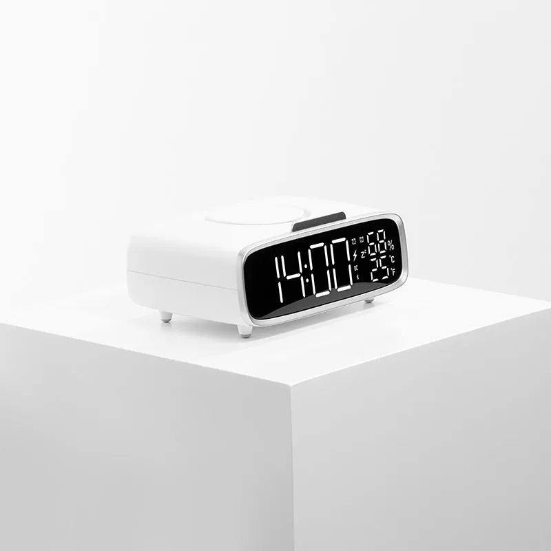 White wireless charging stand with built-in Bluetooth speaker and night light on bedside table