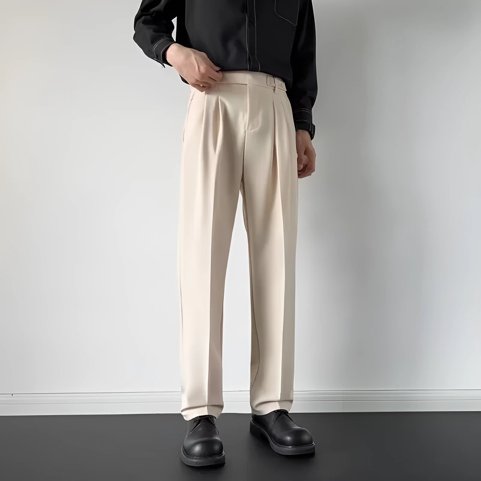Men's straight-leg loose-fit suit trousers in apricot colour on a hanger.
