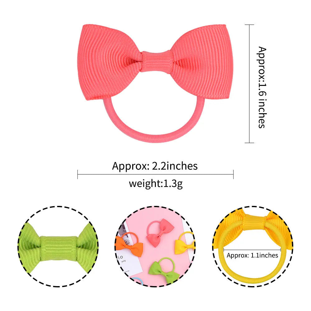Multi-coloured baby hair ties with small grosgrain ribbon bows, soft elastic bands for infants and toddlers.
