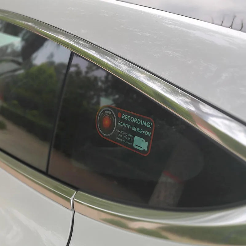 Pair of black and white electrostatic warning stickers for Tesla sentry mode, sized 11cm by 5cm.