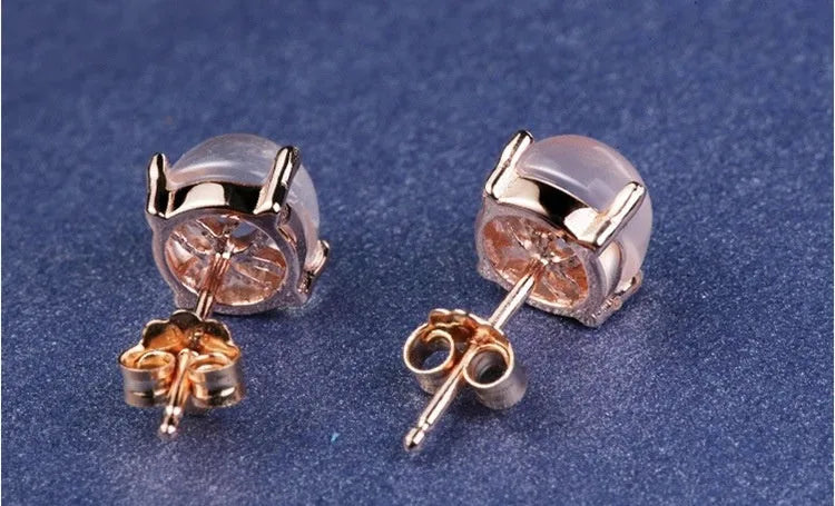 Rose gold plated copper stud earrings with synthetic ross quartz and crystal inlay in drop shape