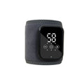 Black electric heating ankle sleeve wrapped around ankle showing heating element placement.