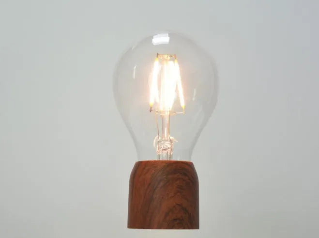 Magnetic levitation floating bulb with imitation wood base and glass enclosure