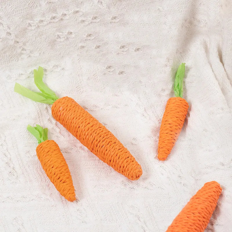 Carrot-shaped paper toys, plastic ringing stones, and textured cat sticks for interactive pet play
