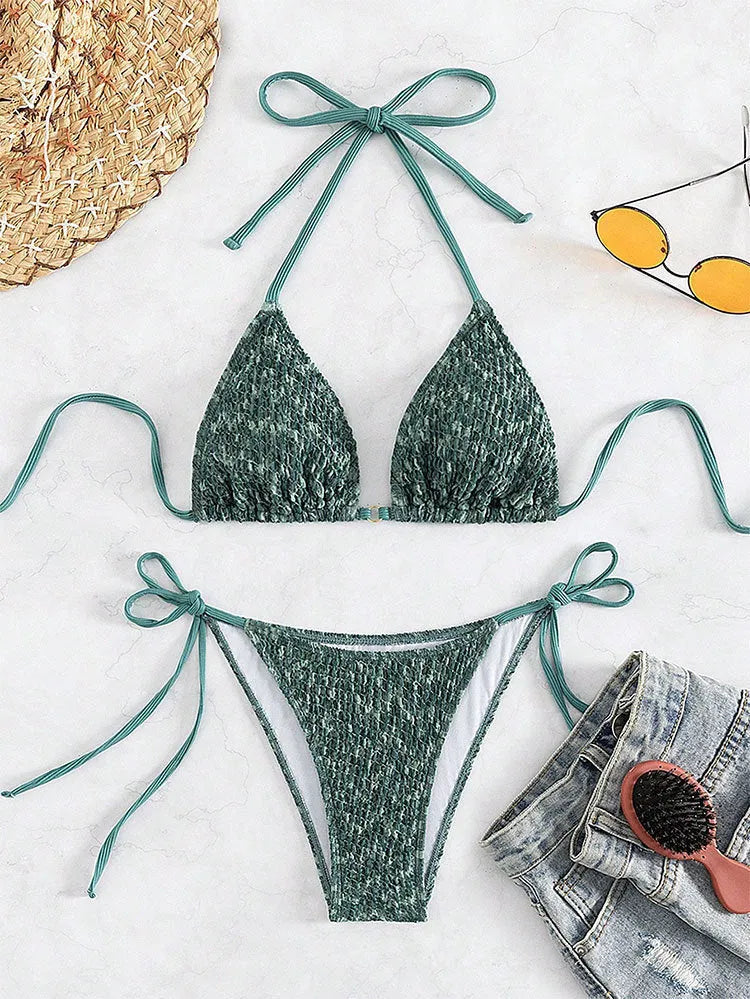 Women's green halter strap backless swimsuit bikini with three-point neck design on mannequin