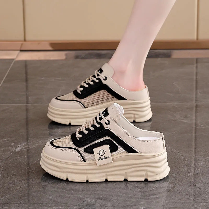 Women's black mesh half slippers with round toe and rubber sole on a plain background